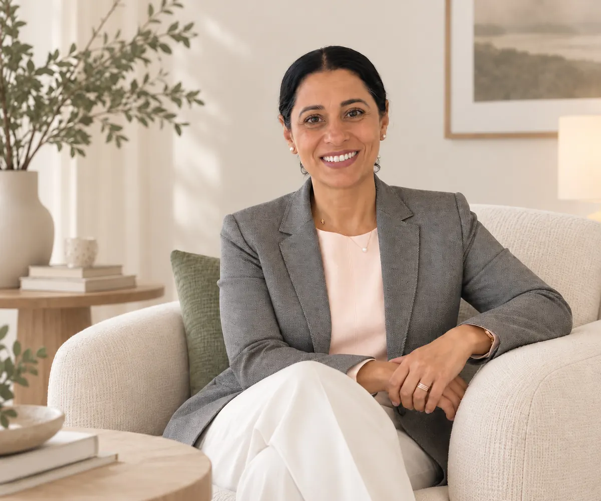 Mandeep Virk, a therapist in Vancouver, seated in an armchair in a softly lit room