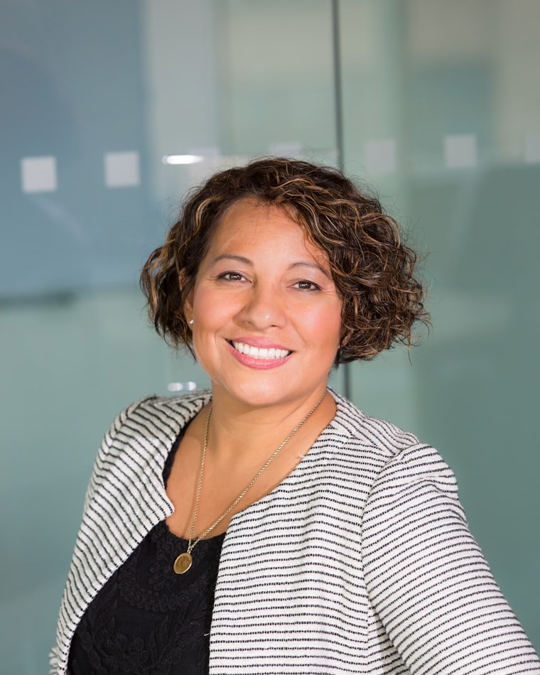 A therapist smiling warmly in a bright office